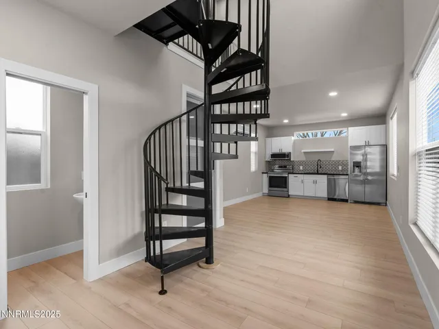 a view of entryway and hall with wooden floor