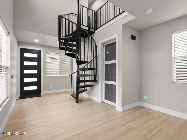 a view of entryway and hall with wooden floor