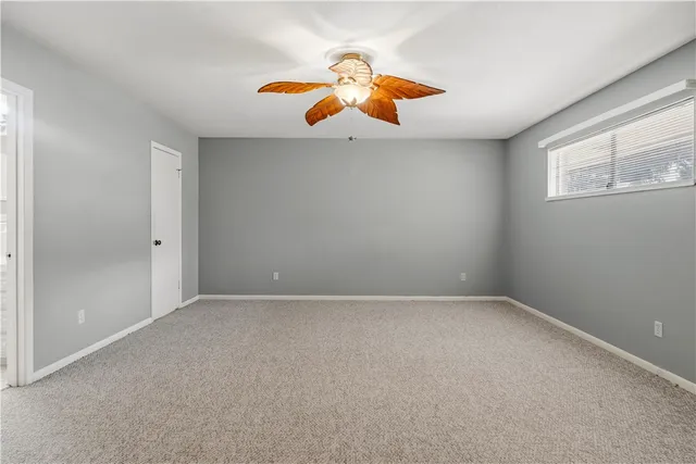 an empty room with windows and white walls