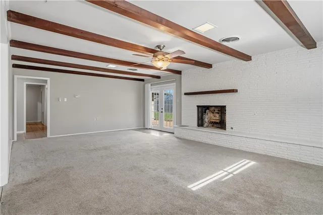 a view of empty room with fireplace