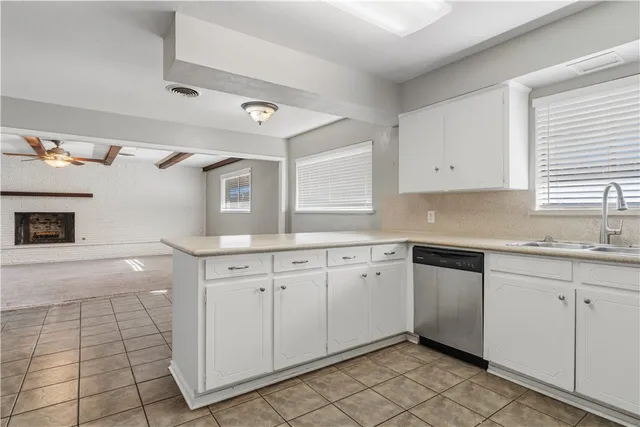 a kitchen with granite countertop white cabinets and white appliances