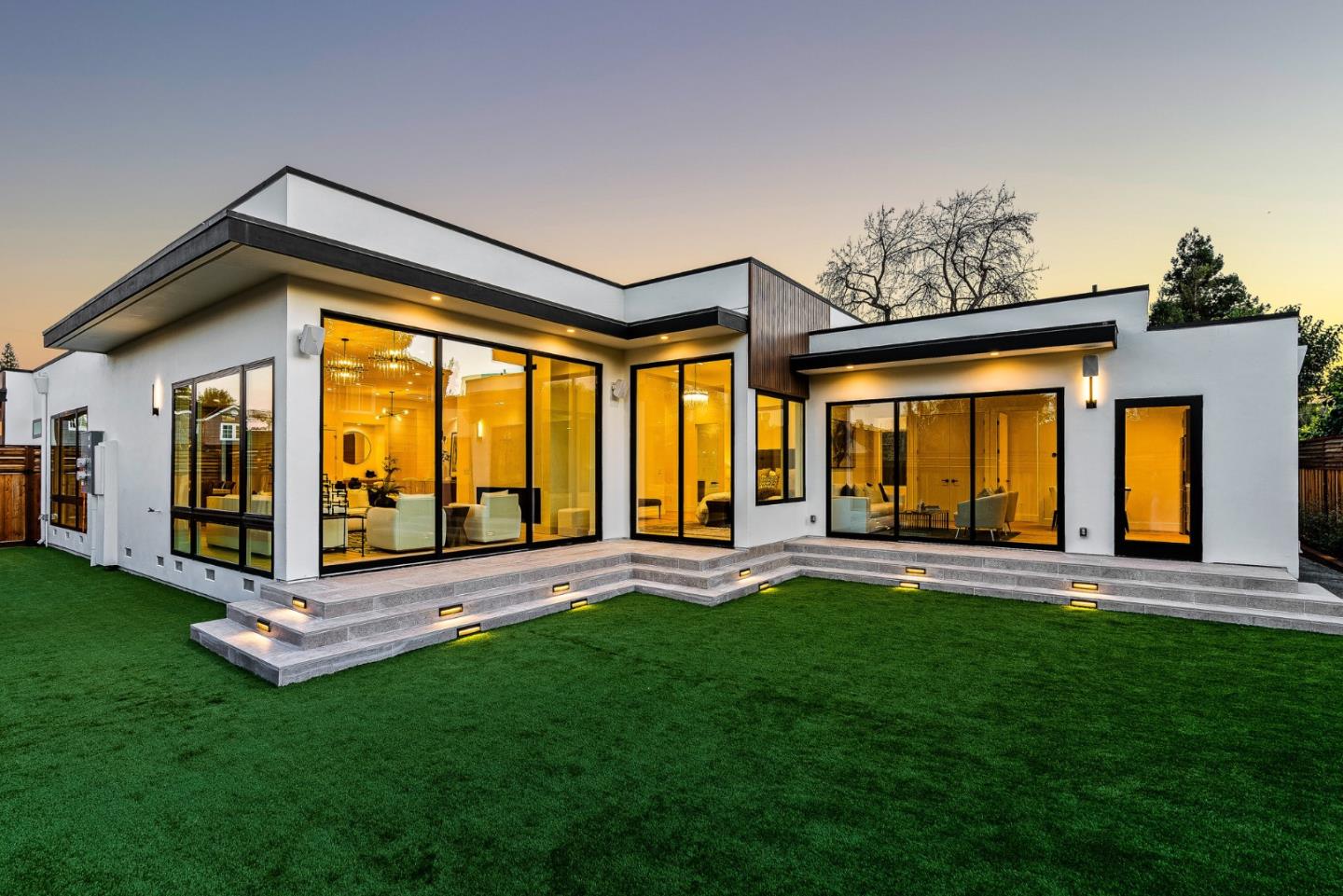 a view of a house with a big yard and a large tree