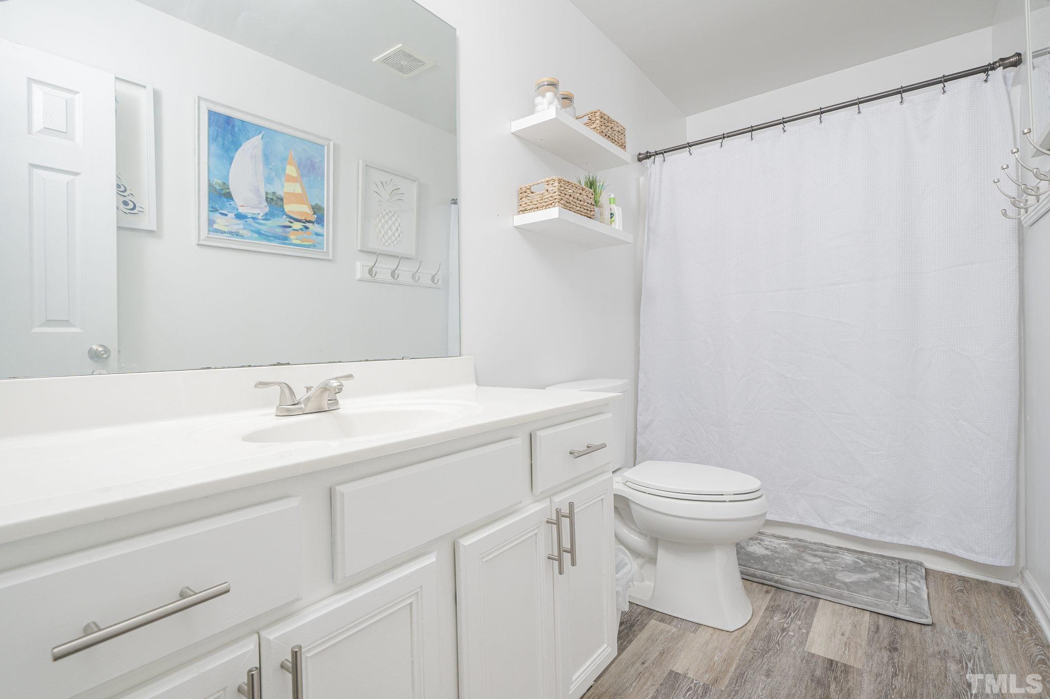 930 Pristine Lane Rolesville, NC 27571 - Photo 13 of 30 a bathroom with a sink toilet and a mirror