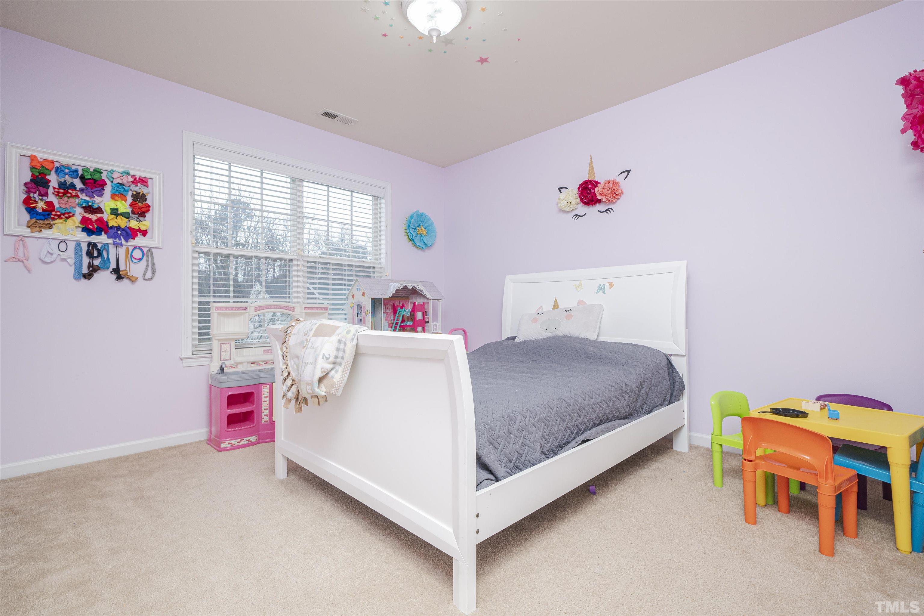 930 Pristine Lane Rolesville, NC 27571 - Photo 14 of 30 a bed room with a bed and a window