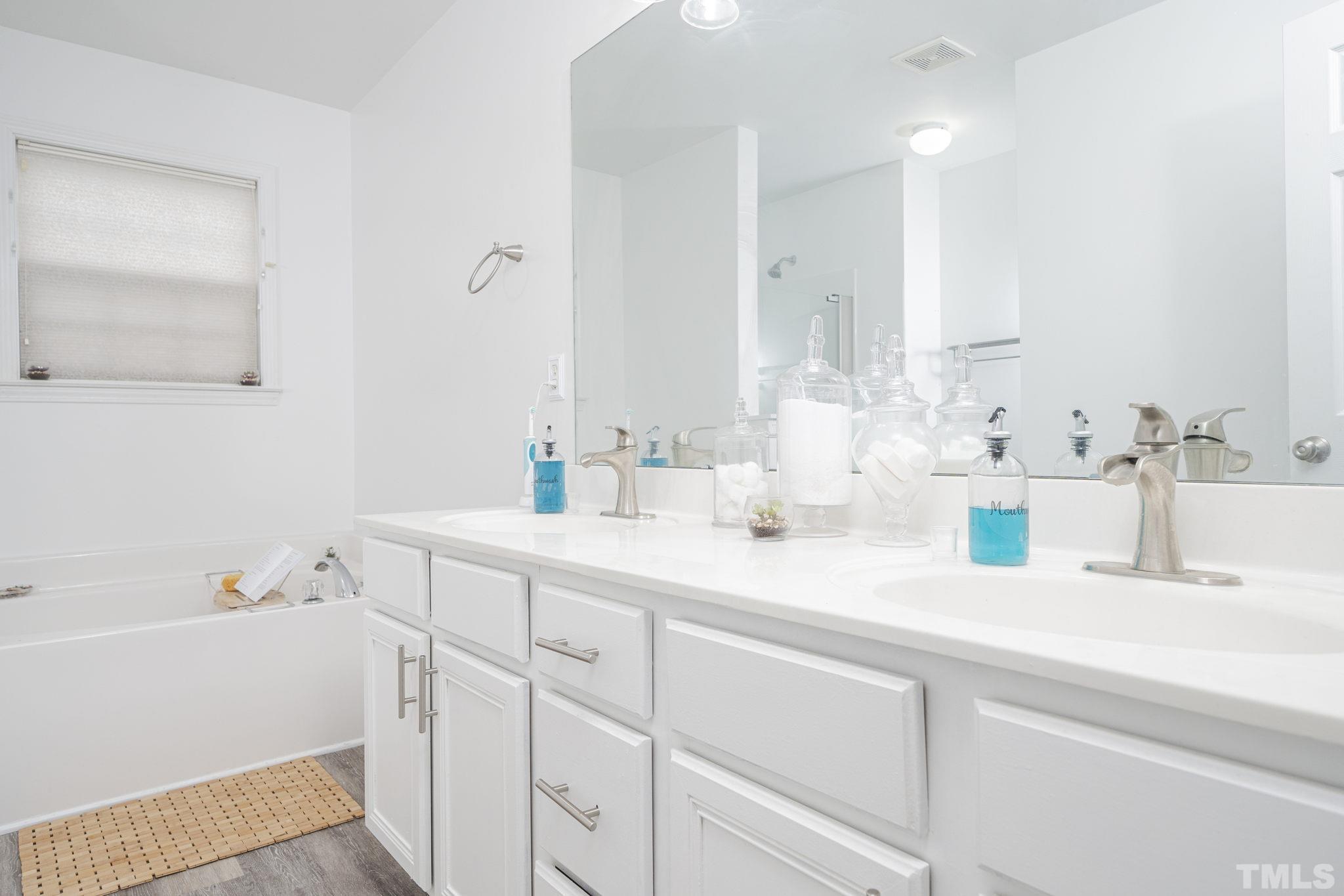 930 Pristine Lane Rolesville, NC 27571 - Photo 15 of 30 a bathroom with a sink and a bathtub