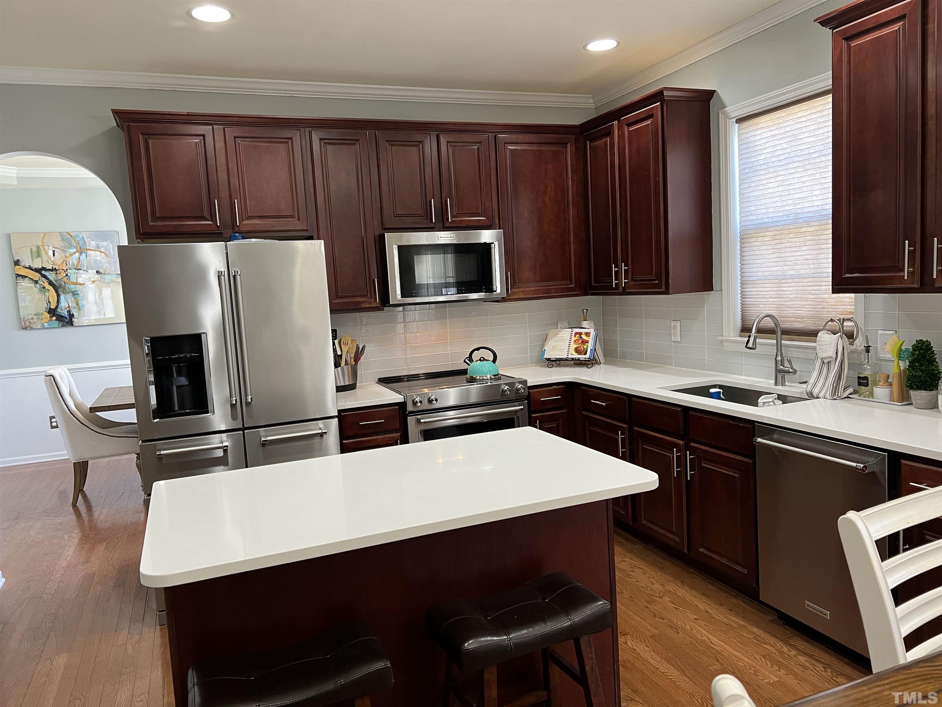 930 Pristine Lane Rolesville, NC 27571 - Photo 2 of 30 a kitchen with a table chairs microwave and refrigerator