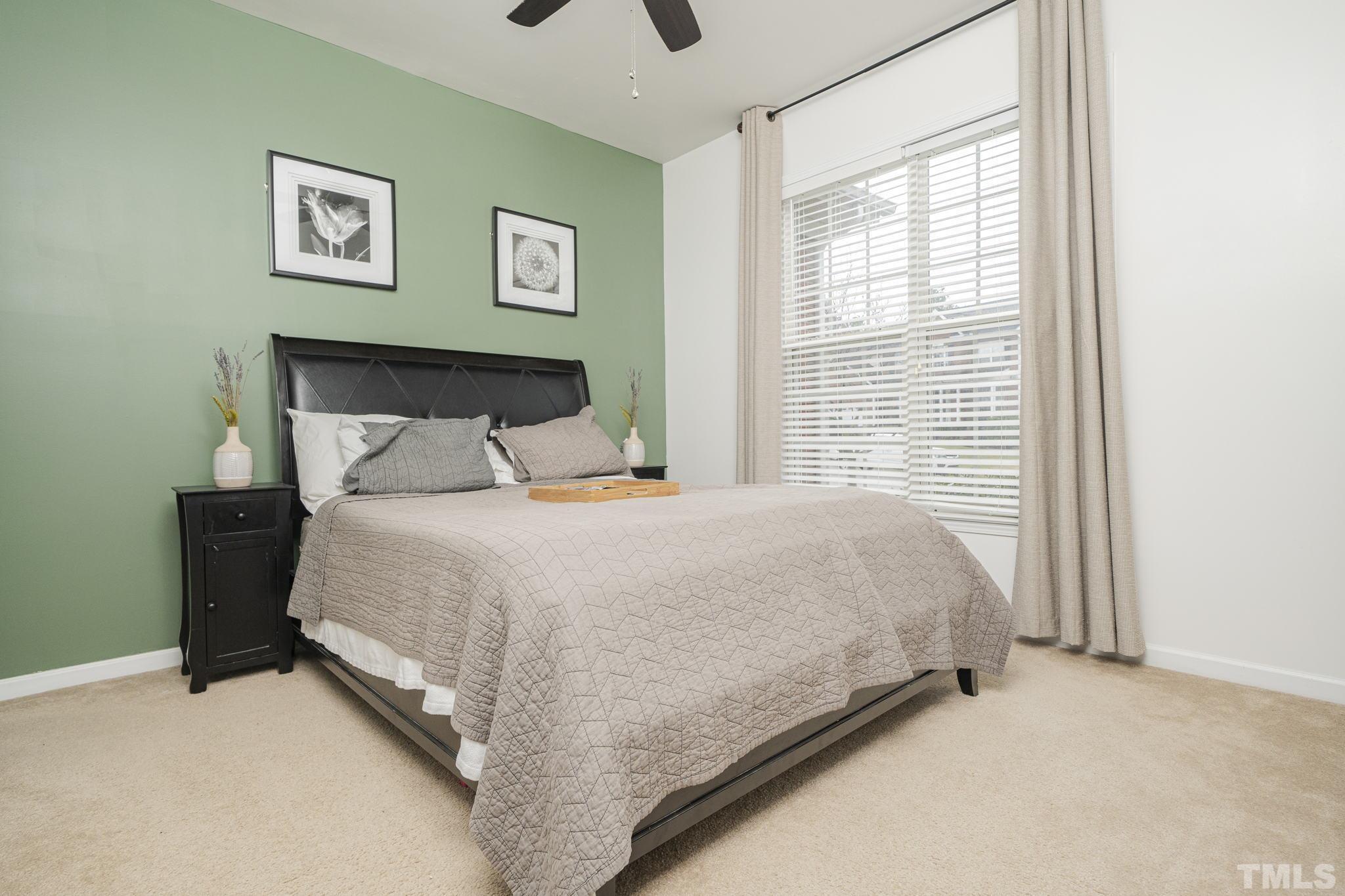 930 Pristine Lane Rolesville, NC 27571 - Photo 21 of 30 a large bed sitting in a bedroom next to a window