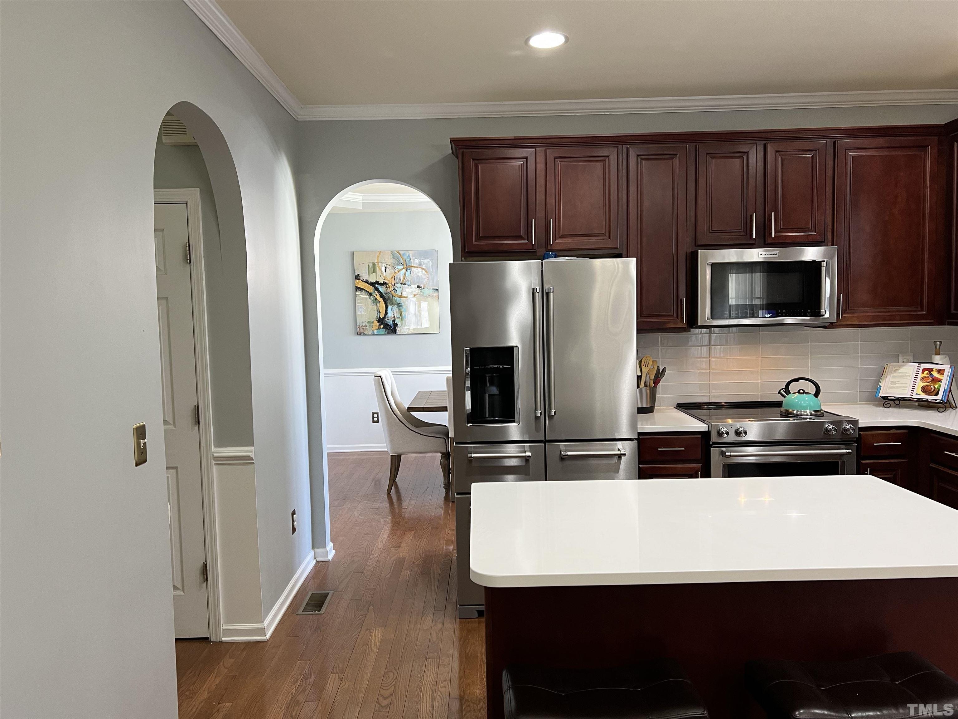 930 Pristine Lane Rolesville, NC 27571 - Photo 5 of 30 a kitchen with stainless steel appliances granite countertop a refrigerator microwave and sink