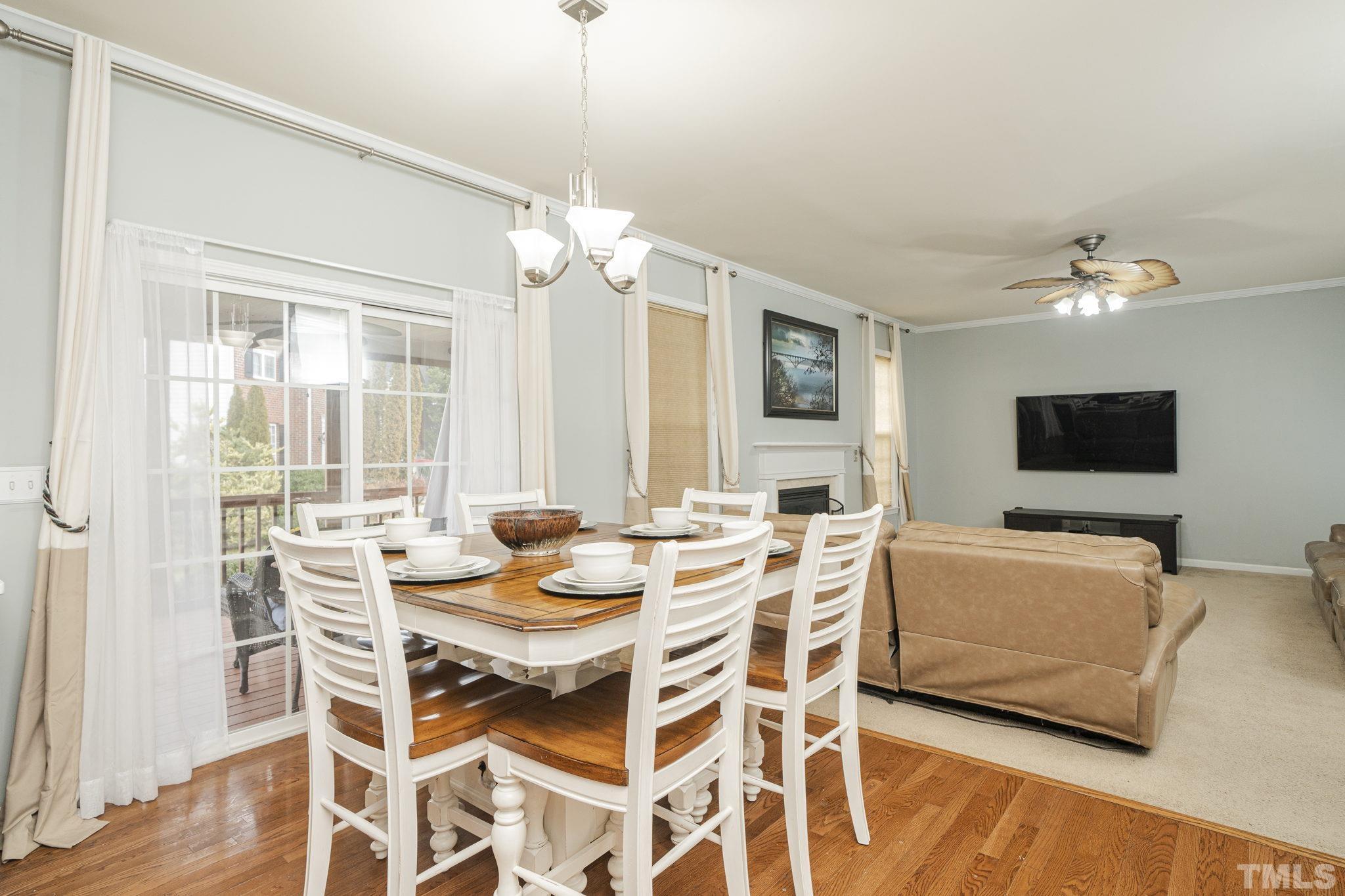 930 Pristine Lane Rolesville, NC 27571 - Photo 9 of 30 a view of a dining room with furniture a chandelier and wooden floor