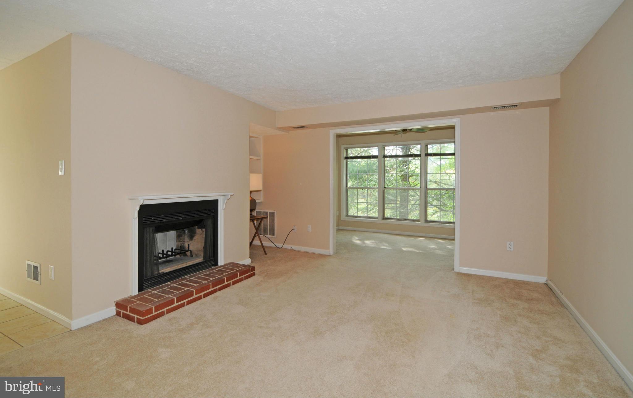 10125 Oakton Terrace Road, Unit 10125 Oakton, VA 22124 - Photo 10 of 30 LIVING RM WITH WOOD BURNING FIREPLACE