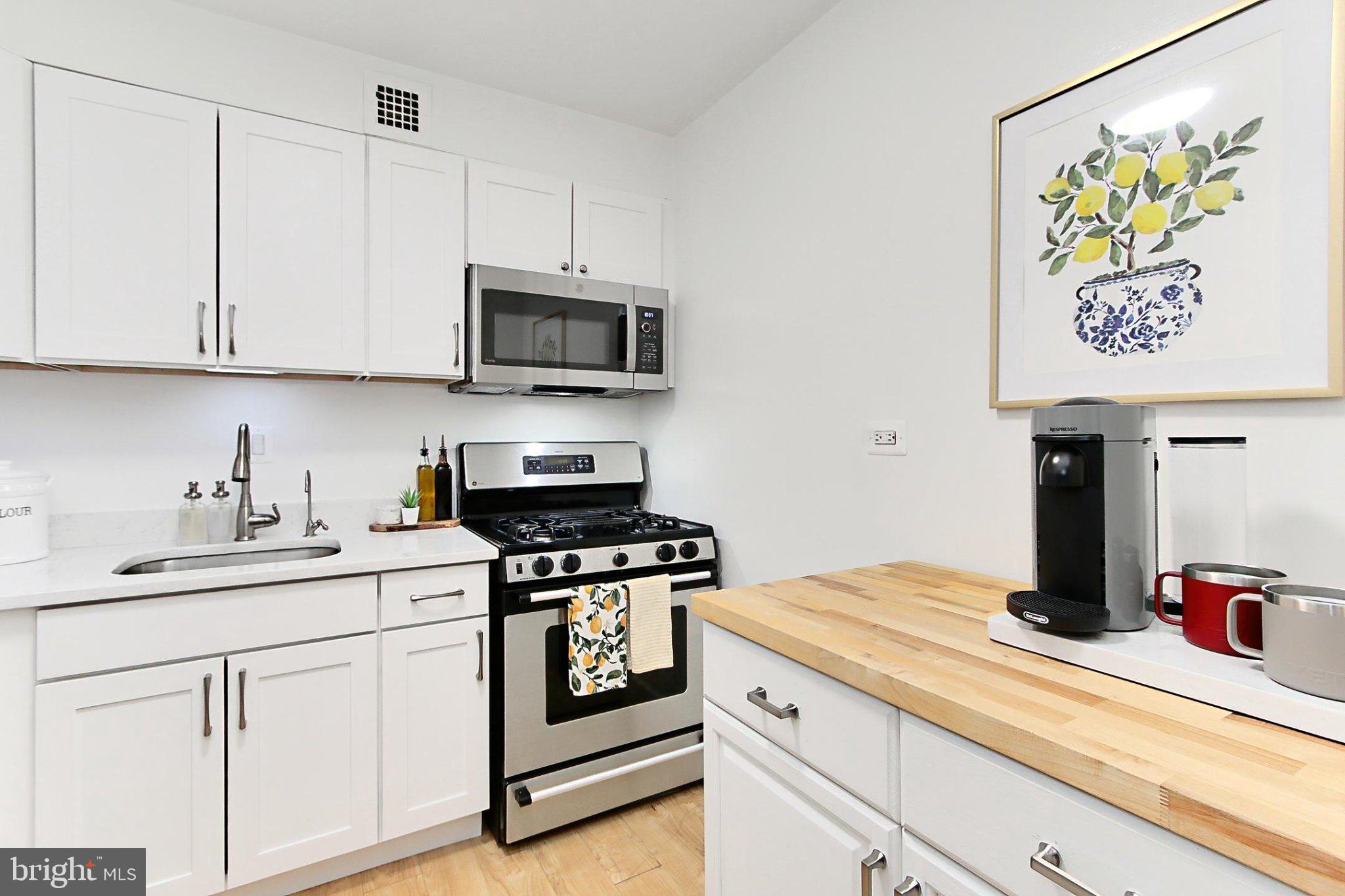 700 7th Street Southwest, Unit 730 Washington, DC 20024 - Photo 4 of 56 a kitchen with stainless steel appliances granite countertop a sink and a stove