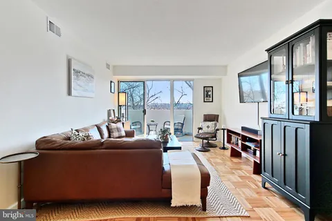 a living room with furniture fireplace and a window