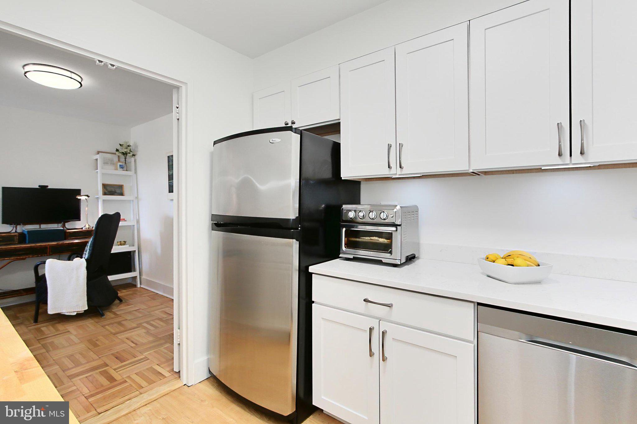 700 7th Street Southwest, Unit 730 Washington, DC 20024 - Photo 9 of 56 a kitchen with a refrigerator and cabinets
