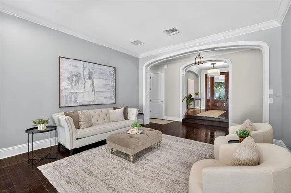 a living room with furniture and wooden floor