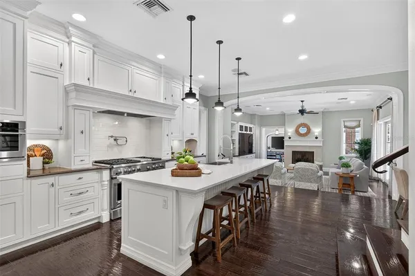 a view of living room with kitchen island furniture and a chandelier
