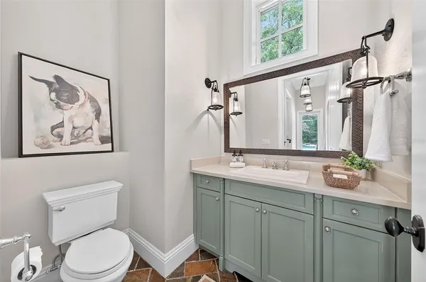 a spacious bathroom with a granite countertop sink mirror and bathtub