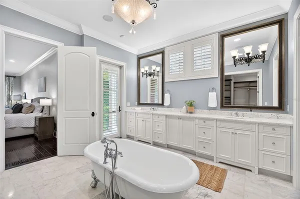 a bedroom with a large bed and a ceiling fan