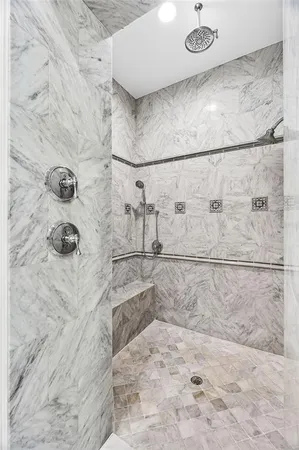 a bathroom with a granite countertop sink a mirror and a bathtub