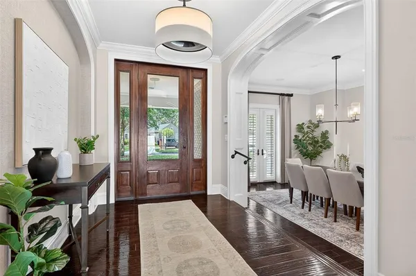 a view of a hallway view with wooden floor and living room