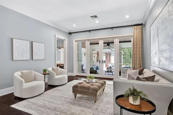 a living room with furniture and a potted plant