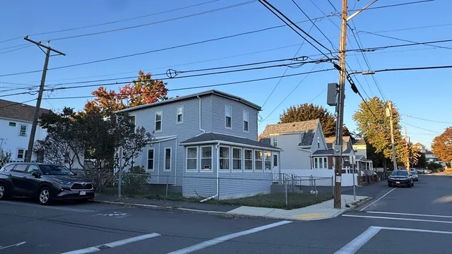 a view of a building and car parked on the road