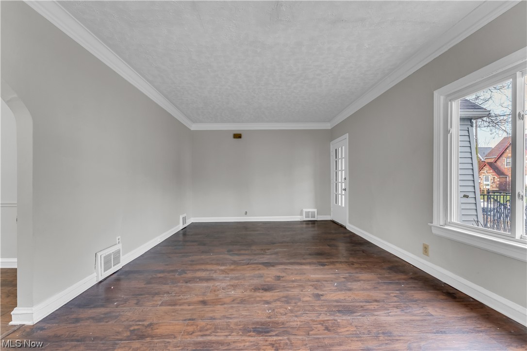 1499 Sherbrook Road South Euclid, OH 44121 - Photo 28 of 41 Spare room featuring dark hardwood / wood-style flooring, crown molding, and a textured ceiling