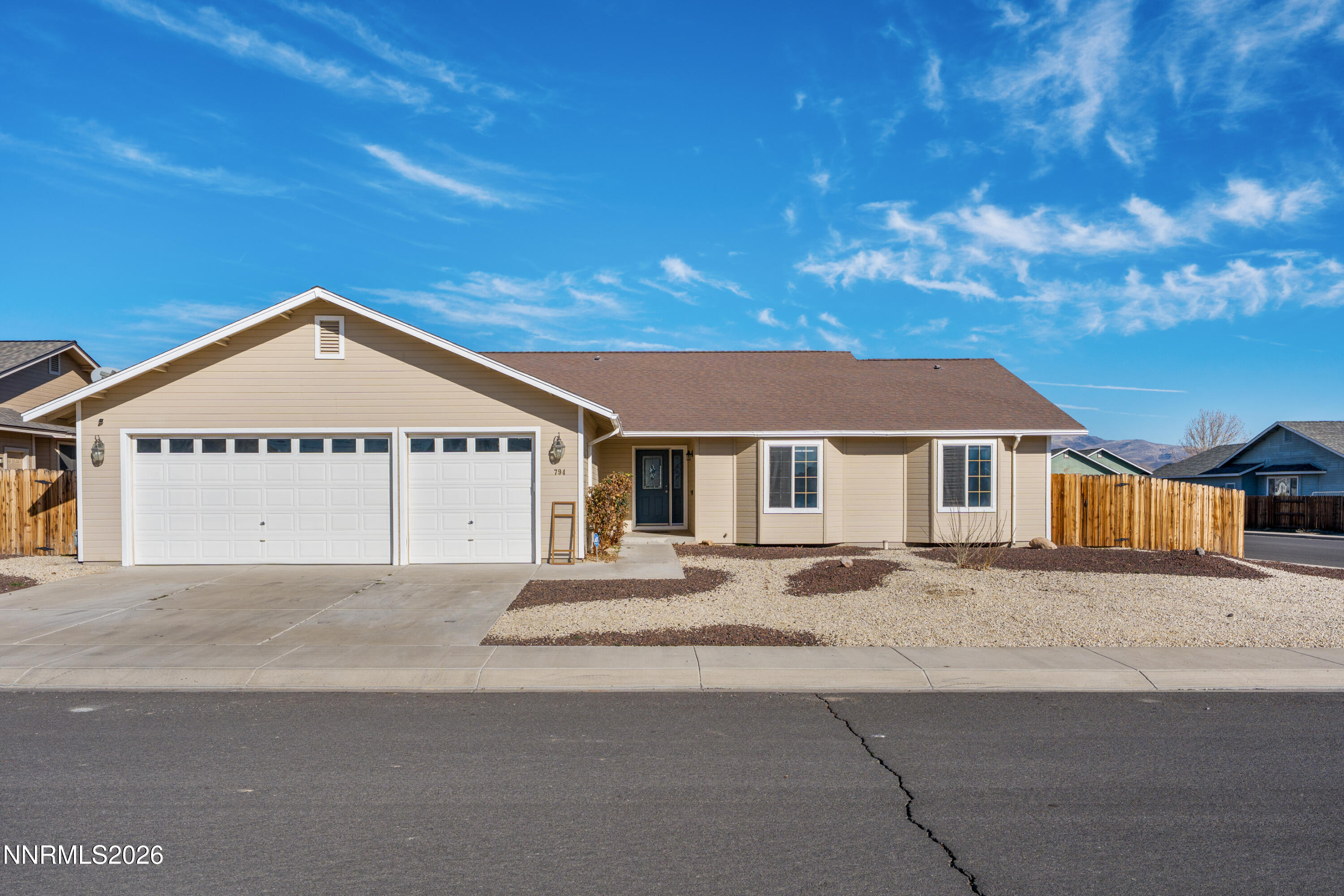794 Mallard Way Fernley, NV 89408 - Photo 1 of 36 a view of a house next to a yard with road and trees
