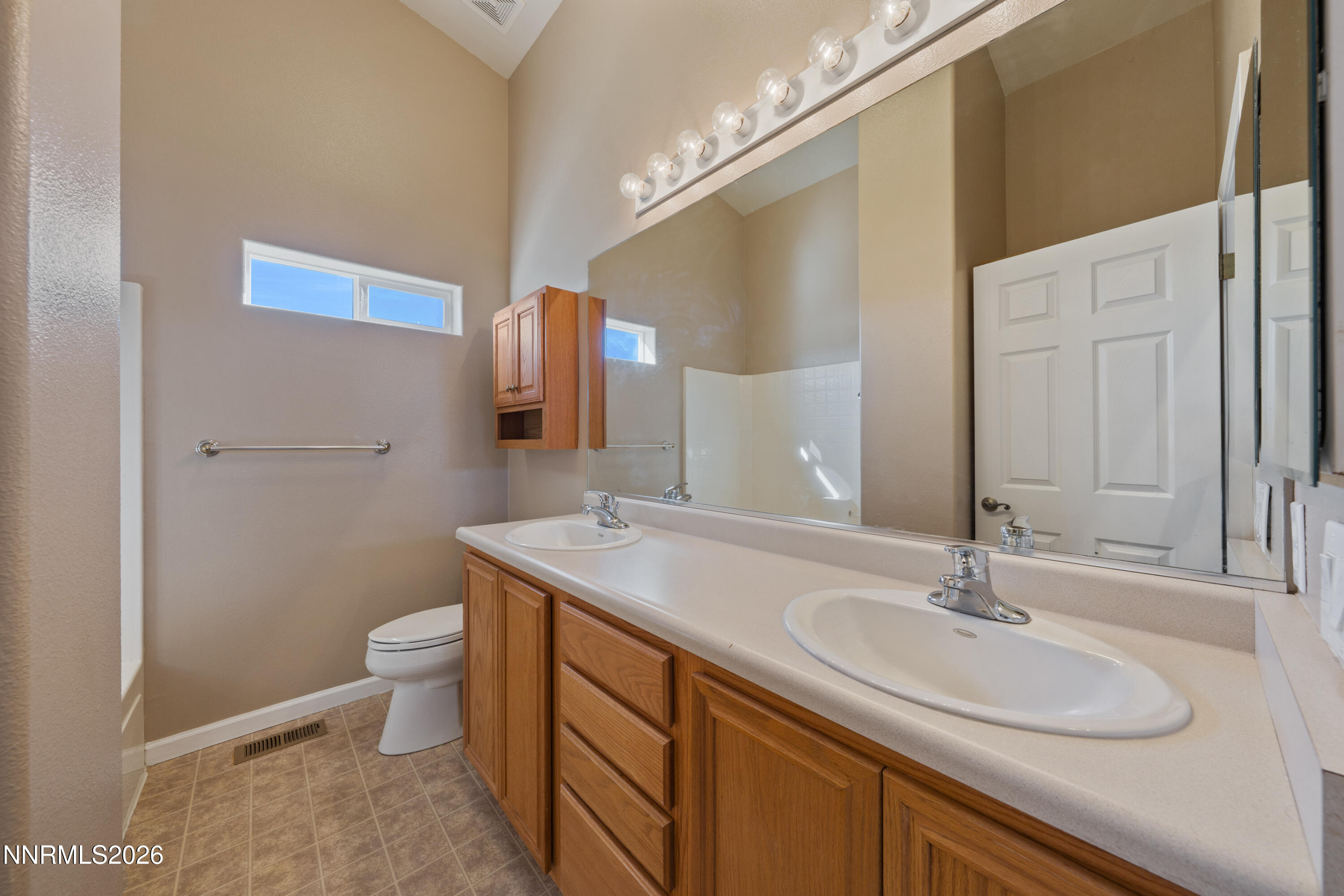 794 Mallard Way Fernley, NV 89408 - Photo 25 of 36 a bathroom with a granite countertop sink a toilet and a mirror