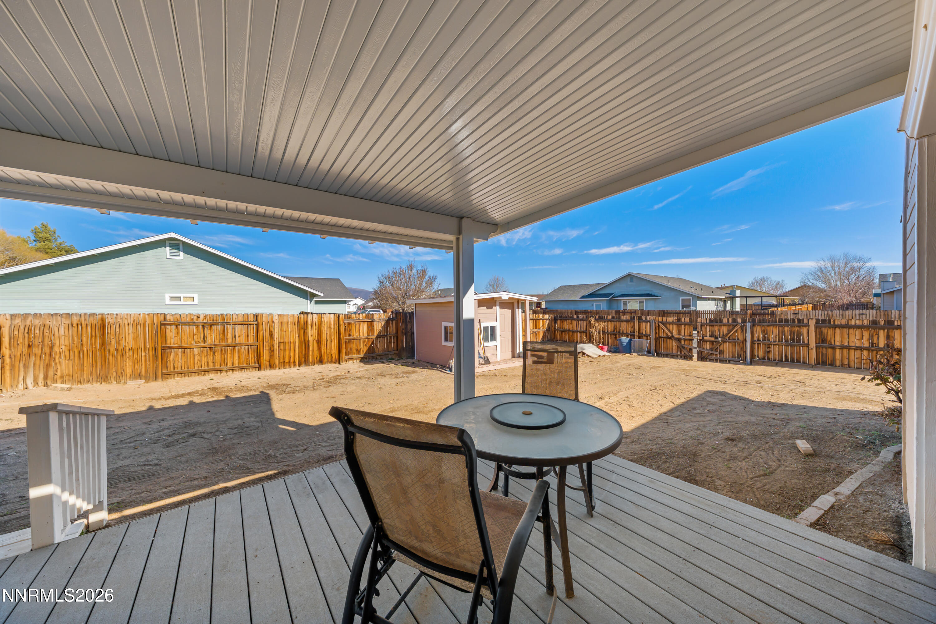 794 Mallard Way Fernley, NV 89408 - Photo 28 of 36 a view of a patio with table and chairs with wooden floor and fence