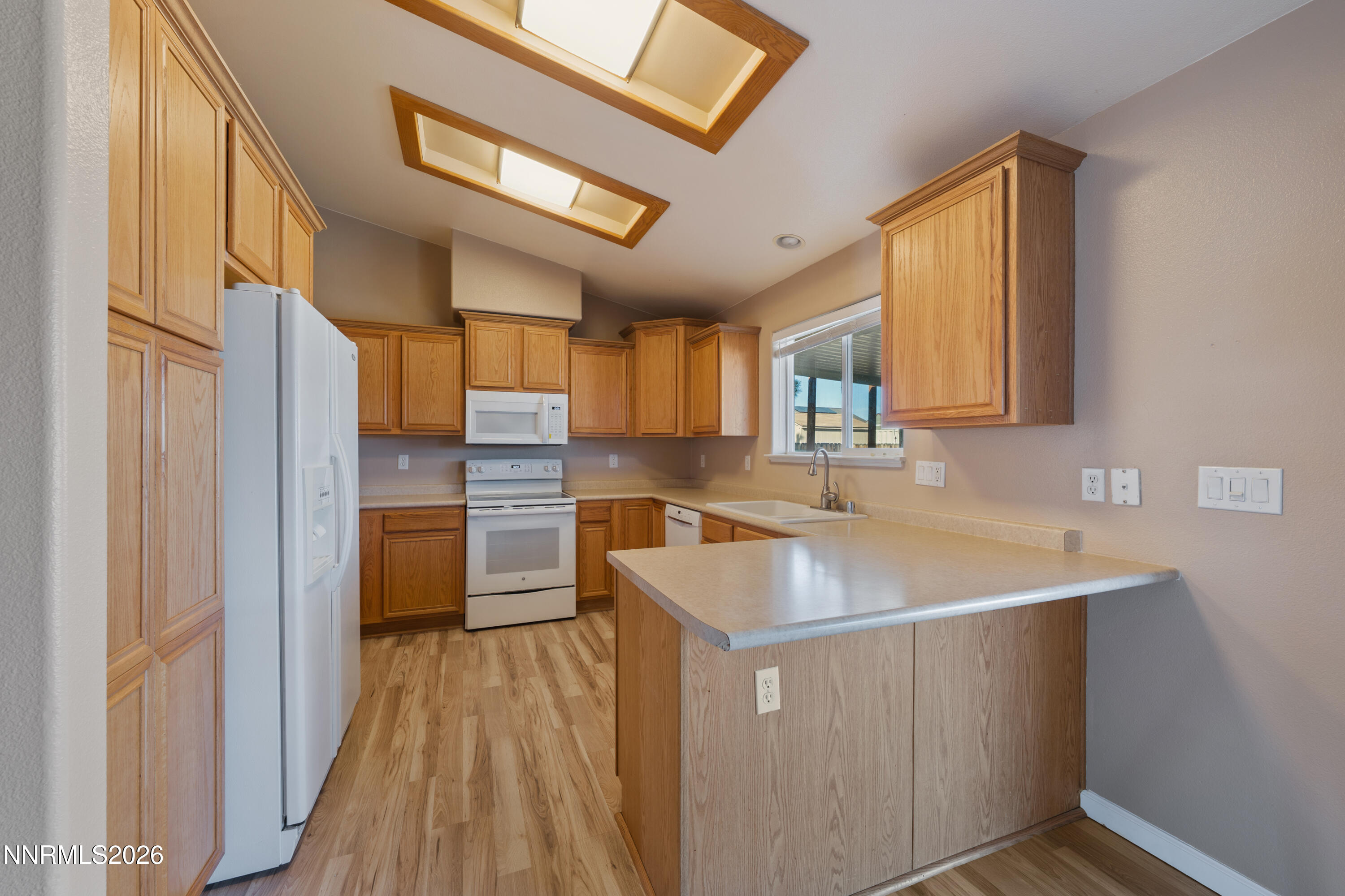 794 Mallard Way Fernley, NV 89408 - Photo 4 of 36 a kitchen with a sink stove and refrigerator