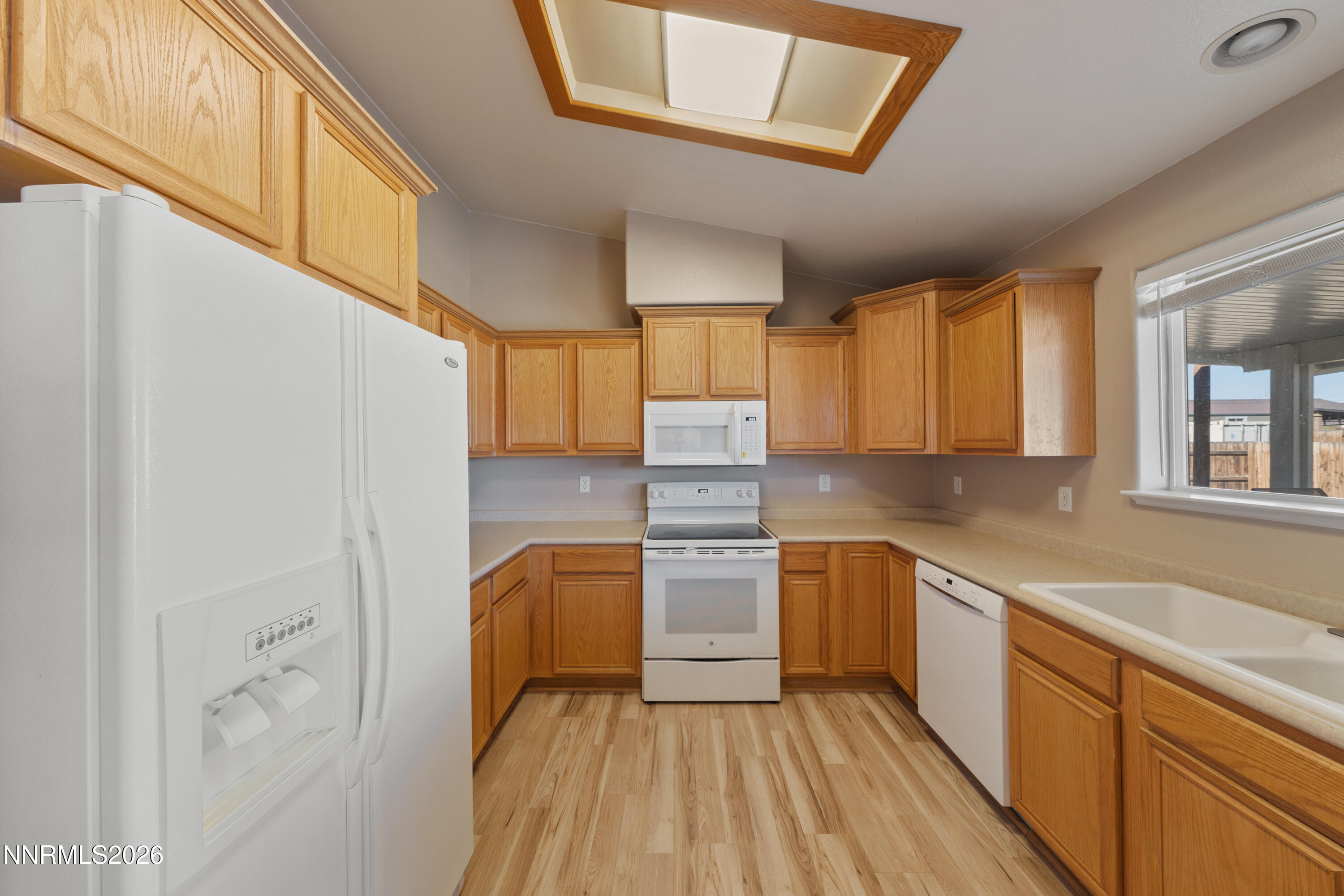 794 Mallard Way Fernley, NV 89408 - Photo 5 of 36 a kitchen with a sink cabinets stainless steel appliances and a window