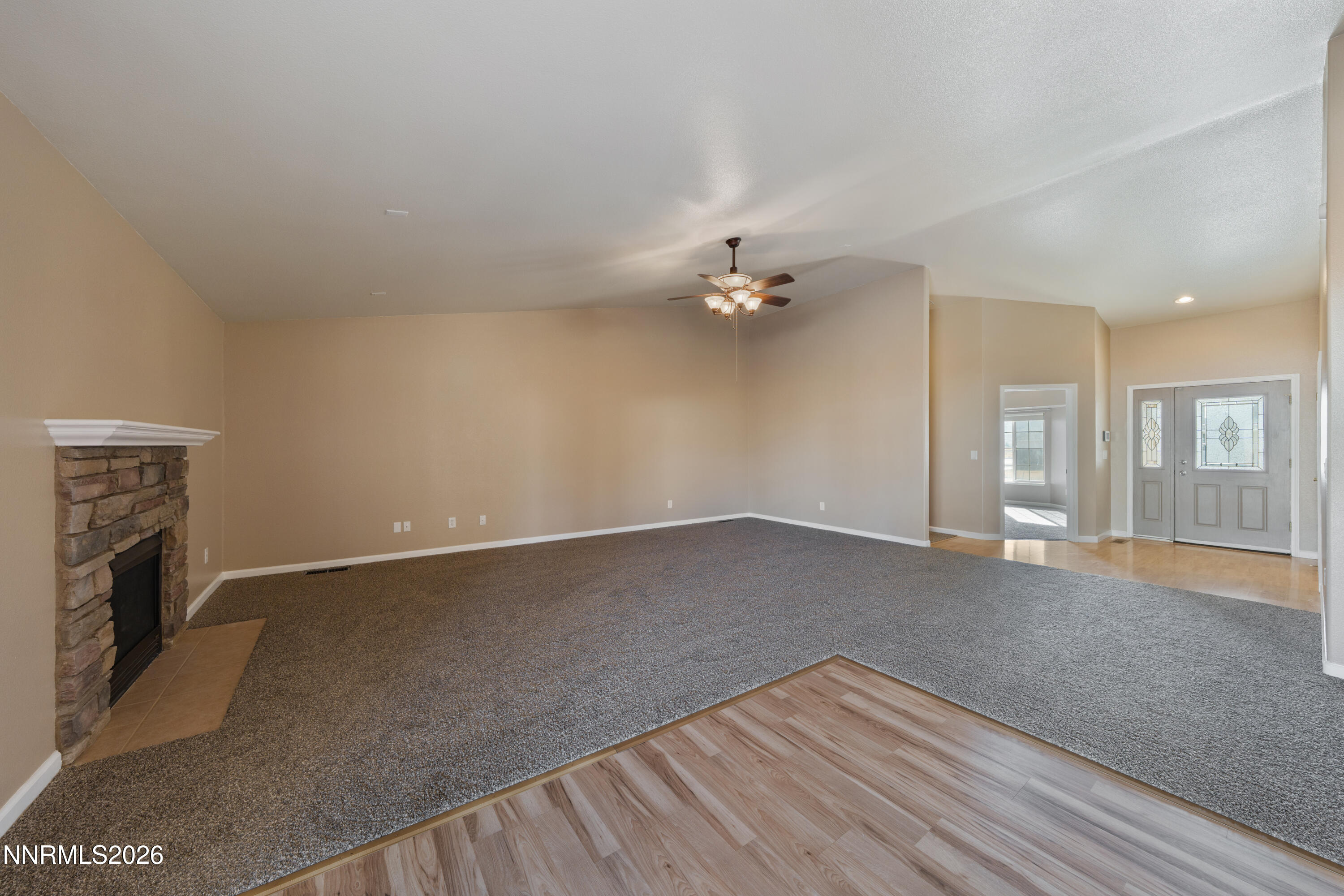 794 Mallard Way Fernley, NV 89408 - Photo 8 of 36 an empty room with a empty space and chandelier fan