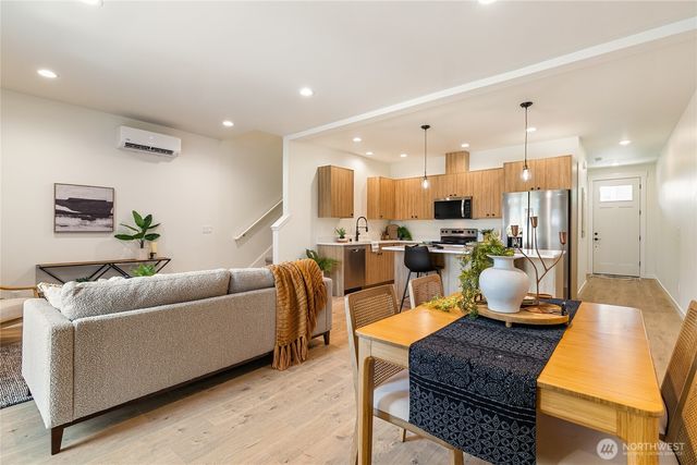 a living room with furniture kitchen and a view of kitchen