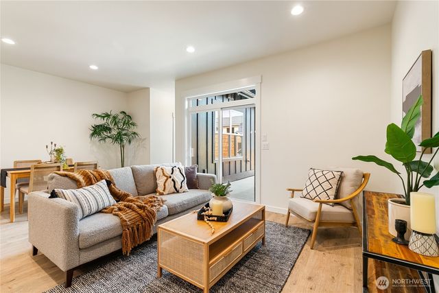 a living room with furniture and a potted plant