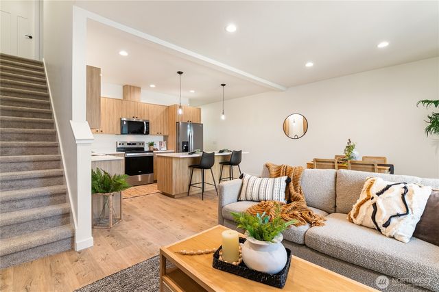 a living room with furniture kitchen and a fireplace