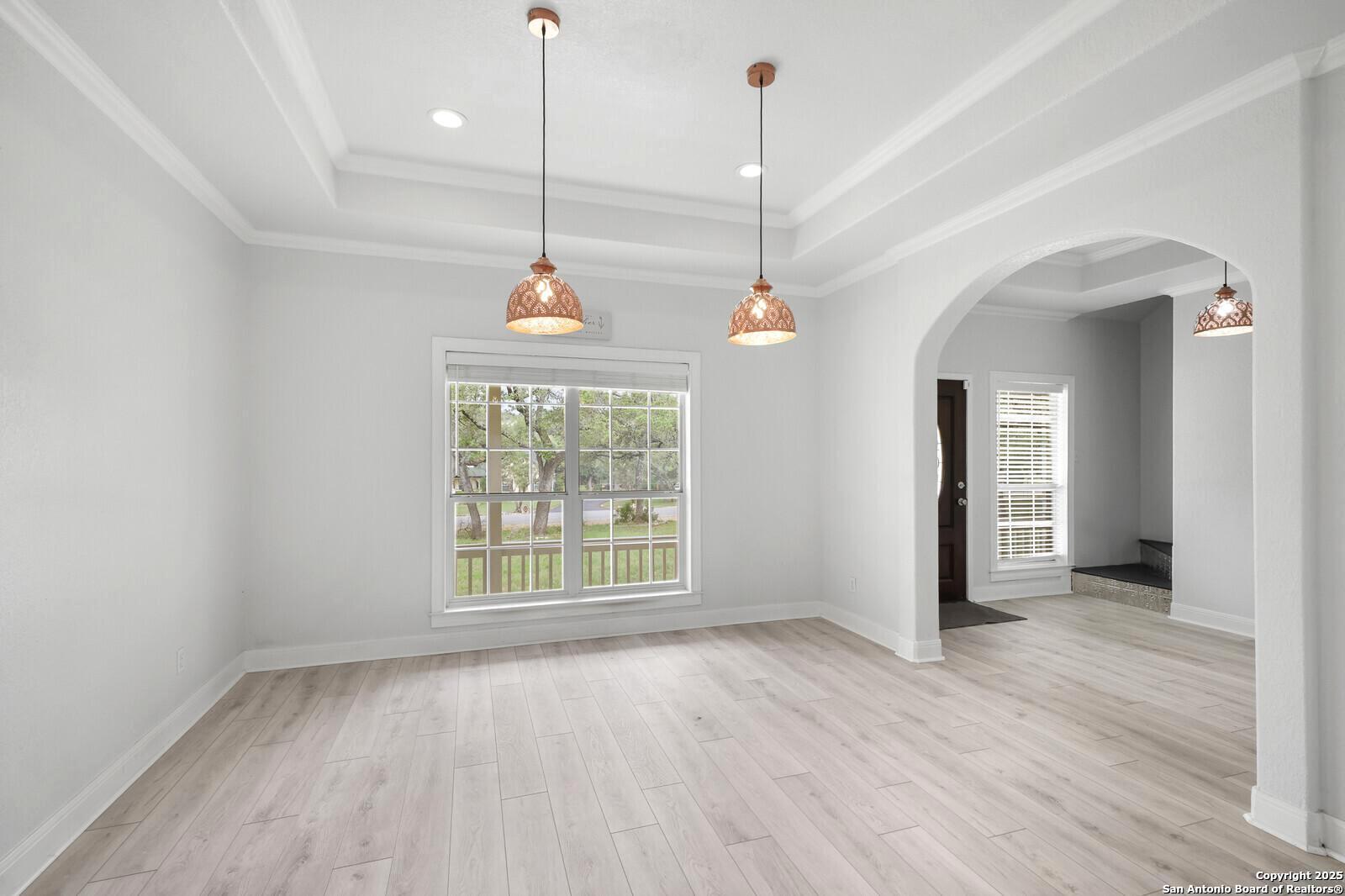 341 Indigo Run Drive Bulverde, TX 78163 - Photo 11 of 37 a view of a room with window wooden floor and chandelier