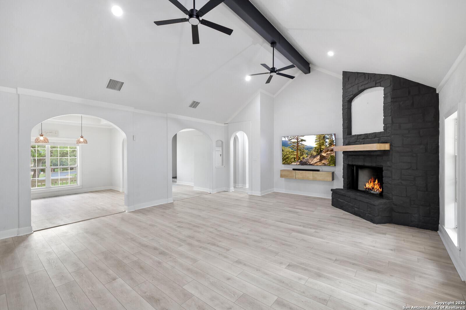 341 Indigo Run Drive Bulverde, TX 78163 - Photo 12 of 37 a view of an empty room with a fireplace and a window