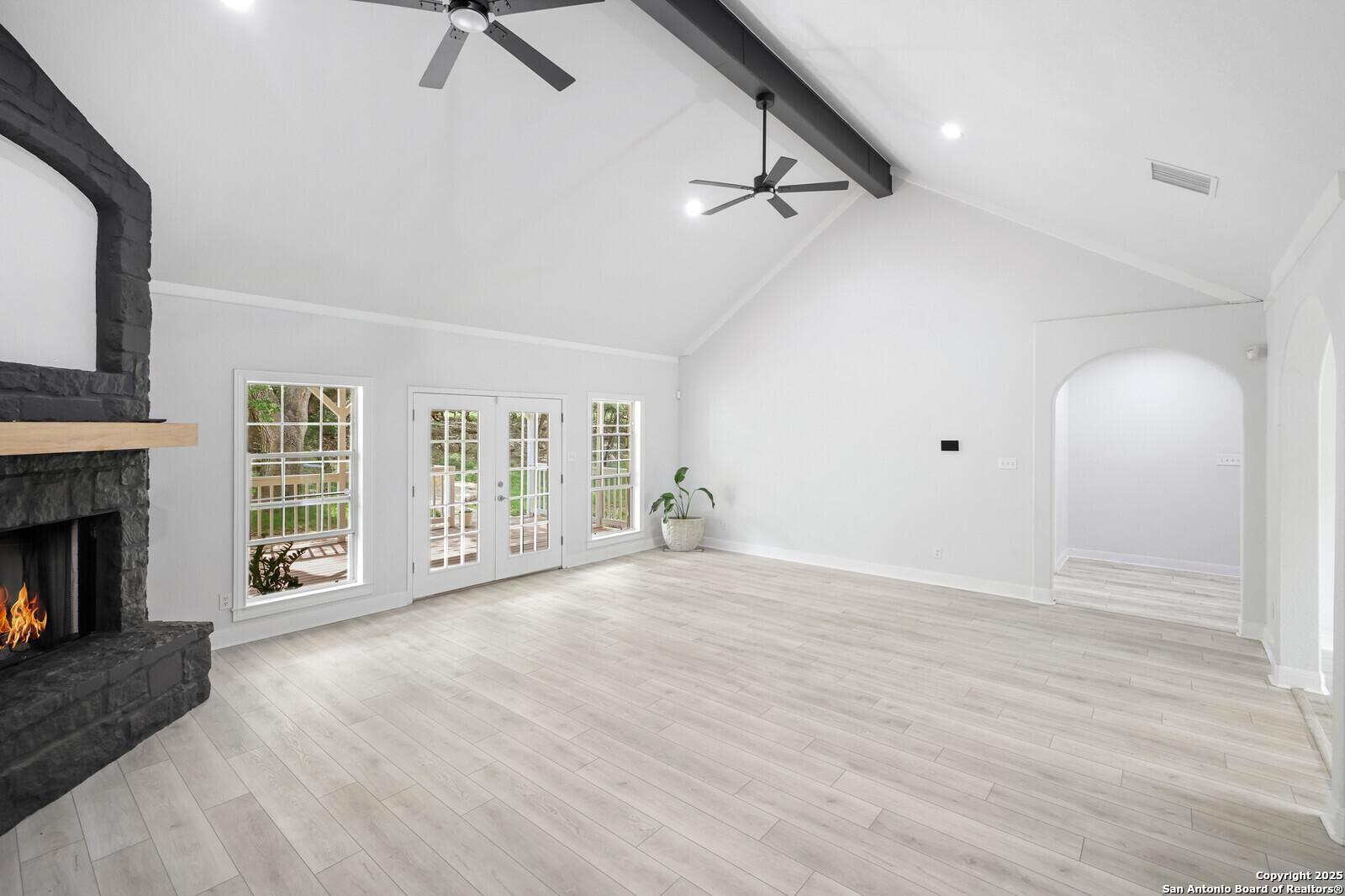 341 Indigo Run Drive Bulverde, TX 78163 - Photo 14 of 37 a view of an empty room with a fireplace and a window
