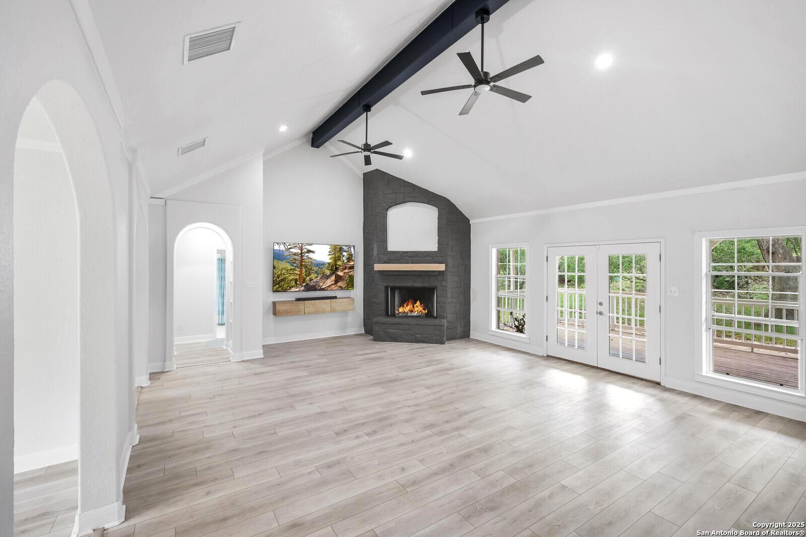 341 Indigo Run Drive Bulverde, TX 78163 - Photo 15 of 37 a view of an empty room with a fireplace and a window