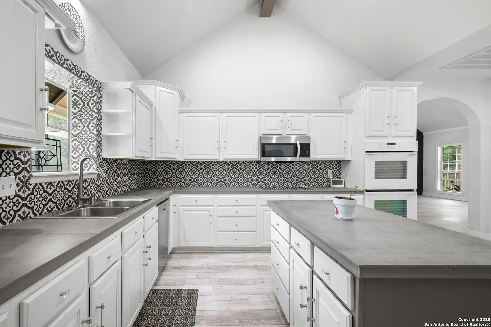 341 Indigo Run Drive Bulverde, TX 78163 - Photo 18 of 37 a kitchen with stainless steel appliances granite countertop a sink dishwasher stove and oven