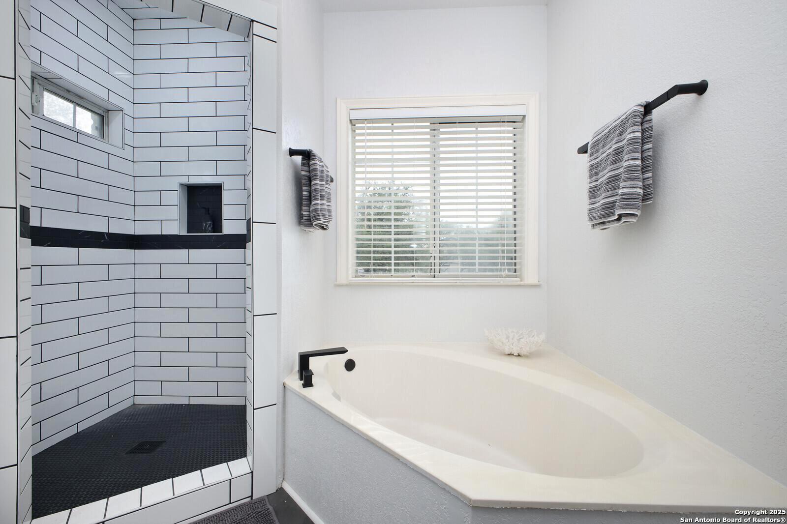 341 Indigo Run Drive Bulverde, TX 78163 - Photo 24 of 37 a bathroom with a bathtub and a shower