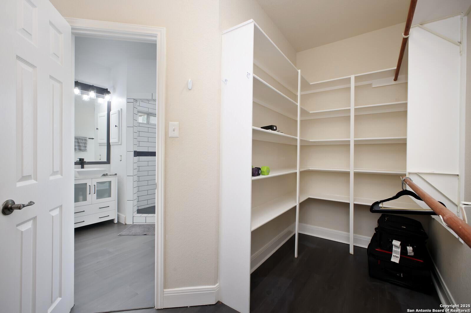 341 Indigo Run Drive Bulverde, TX 78163 - Photo 25 of 37 a view of walk in closet with empty racks