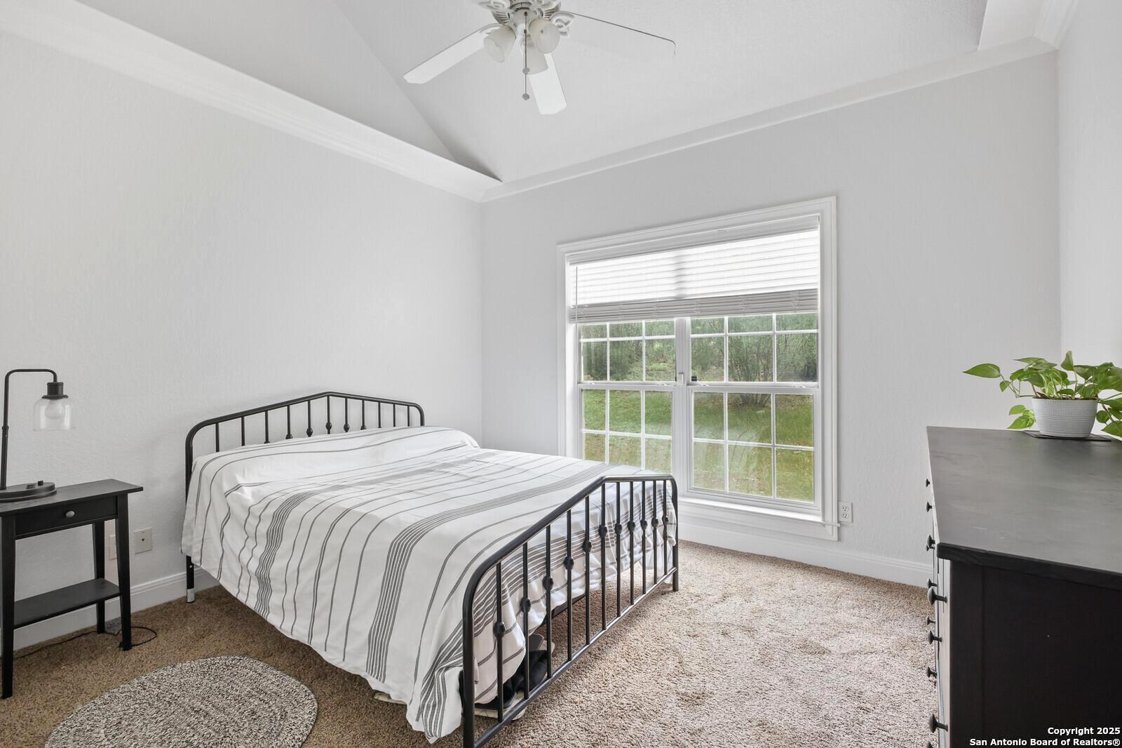 341 Indigo Run Drive Bulverde, TX 78163 - Photo 27 of 37 a bedroom with a bed and a window