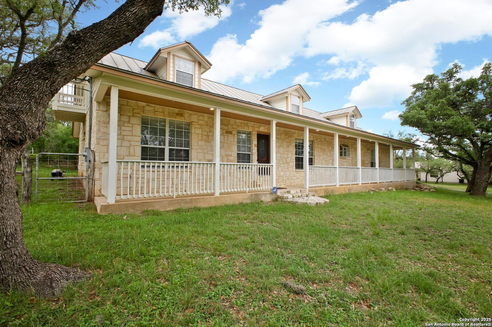 341 Indigo Run Drive Bulverde, TX 78163 - Photo 4 of 37 front view of a house with a yard