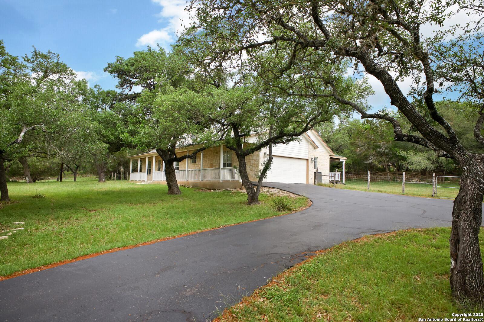 341 Indigo Run Drive Bulverde, TX 78163 - Photo 5 of 37 a view of a yard with plants and trees