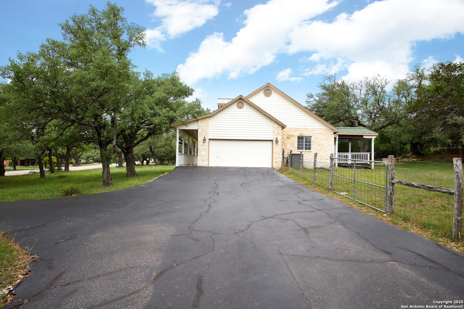 341 Indigo Run Drive Bulverde, TX 78163 - Photo 6 of 37 a view of house with backyard and trees