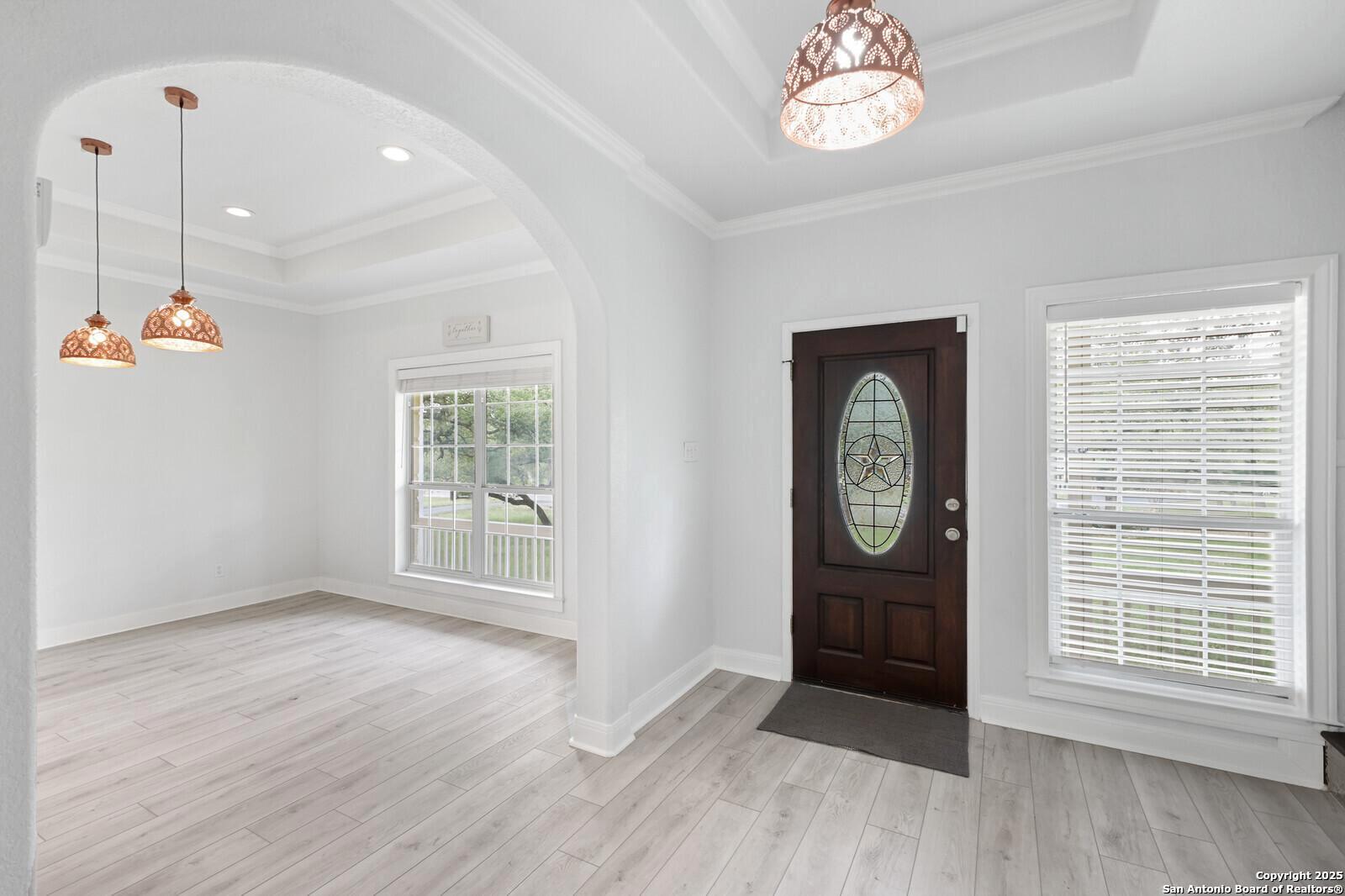 341 Indigo Run Drive Bulverde, TX 78163 - Photo 7 of 37 a view of an empty room with a window and wooden floor