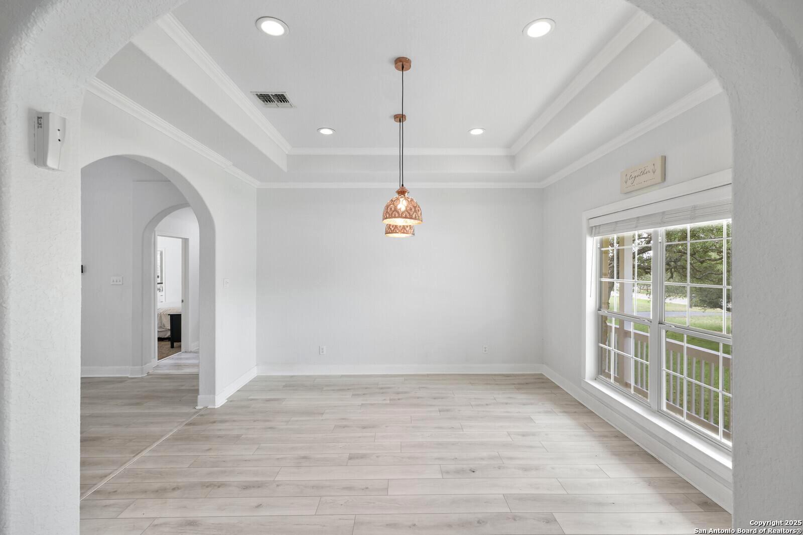 341 Indigo Run Drive Bulverde, TX 78163 - Photo 8 of 37 an empty room with wooden floor and windows