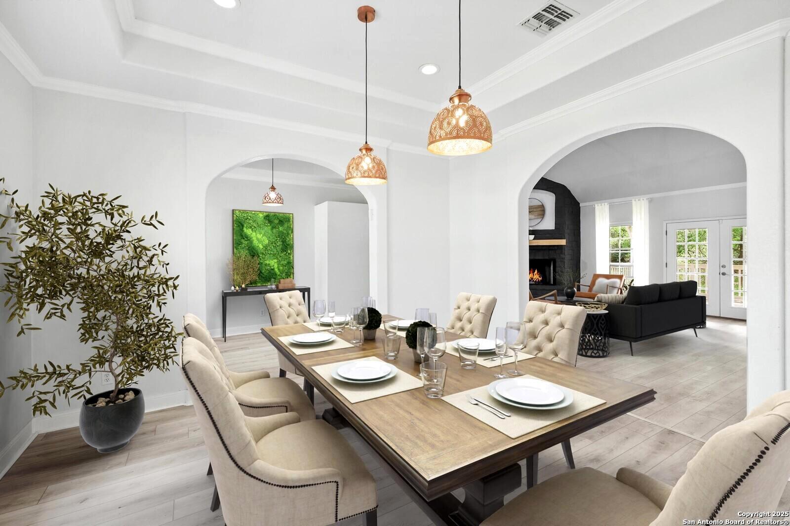 341 Indigo Run Drive Bulverde, TX 78163 - Photo 10 of 37 a view of a dining room and livingroom with furniture wooden floor a chandelier