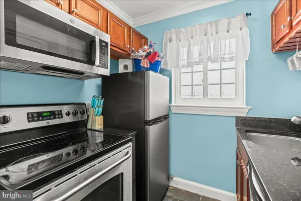 a kitchen with stainless steel appliances a refrigerator a stove and a sink